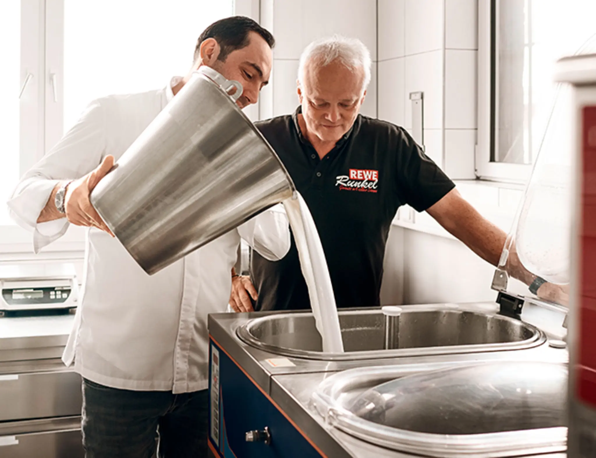 Roberto Ghirloni und Frank Runkel stellen gemeinsam in der Eisküche Eis her.